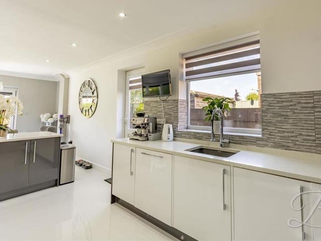 The kitchen comes complete with a modern range of gloss wall and base units with granite worktop over, inset sink and drainer. An island, TV point and underfloor heating are additional features.