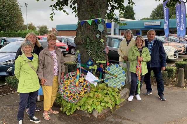 Warsop and district U3A group are all smiles after decorating Mansfield Road with yarn as part of their 'Tour of Britain' display.