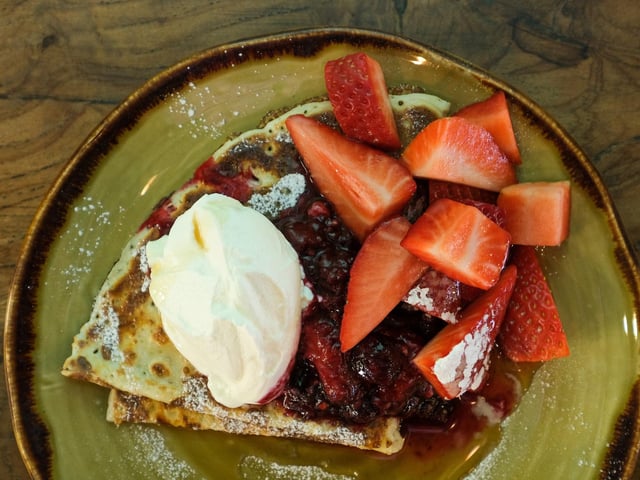 Now that you've made your first pancake, why not make more. Try experimenting with different flavours to find your favourite. Here, Carl has added strawberry kompot, cream, maple syrup and chopped strawberries.