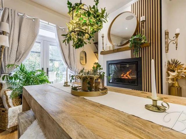 The dining area is complemented by a contemporary fireplace.