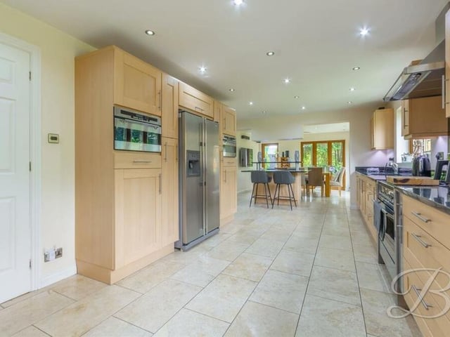 With integrated appliances and ample dining space, the kitchen is perfect for culinary enthusiasts. Those appliances include an oven with hob and extractor fan over, while there is space for a double fridge/freezer. Tiled flooring and spotlights add to the room's style and sparkle.