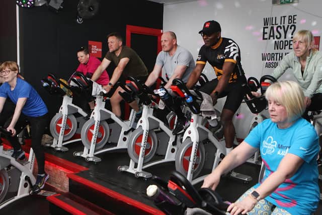 Lloyd Scott (third from right), co-owner of the Fitness Box gym, leads the spin-bike section of the Ironman Challenge.