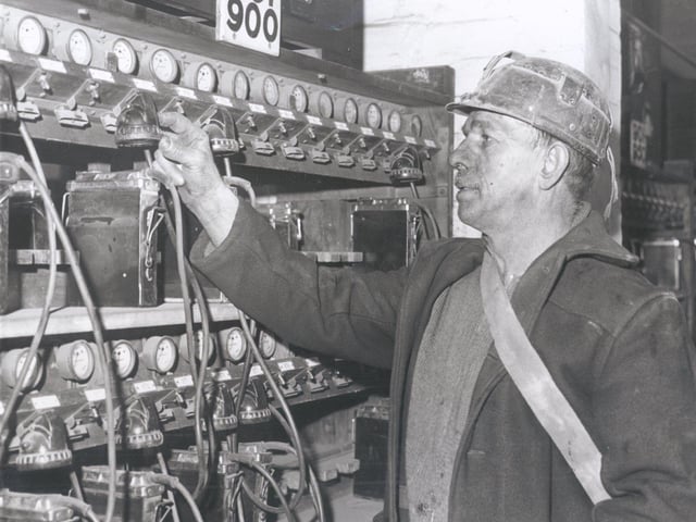 Bill Frost puts his lamp on charge after finishing his shift at Mansfield Colliery..Jan 23rd 1963