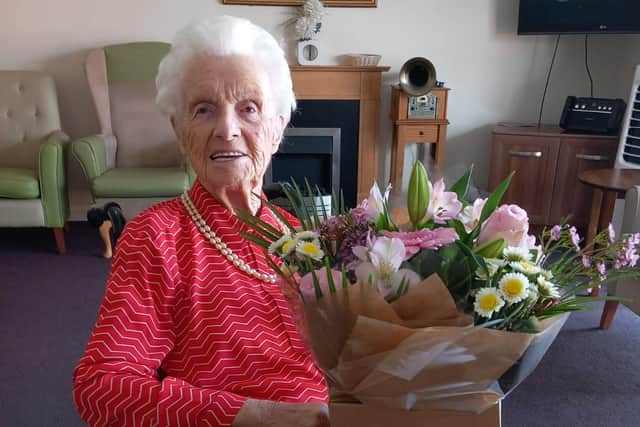 All smiles and flowers - that's former Mansfield midwife Edith Pearson at her 106th birthday party.