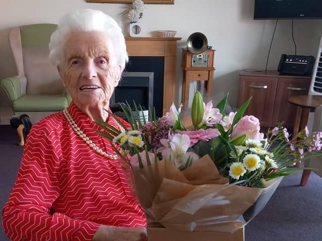 All smiles and flowers - that's former Mansfield midwife Edith Pearson at her 106th birthday party.