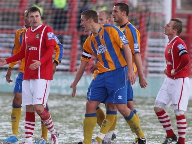 Players react after Wrexham's Andy Mangan is sent off.
