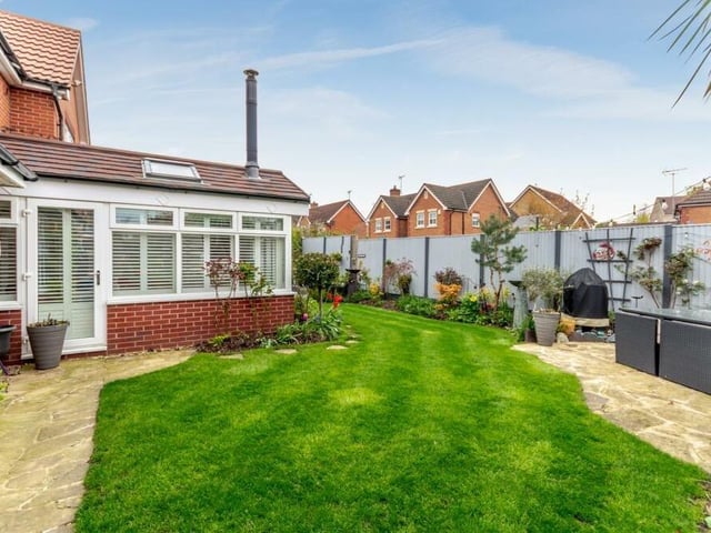 There are well-maintained, landscaped gardens at the front and back of Holly End, with lawns, borders and colourful plants and shrubs. Here is the back, directly outside the garden room.