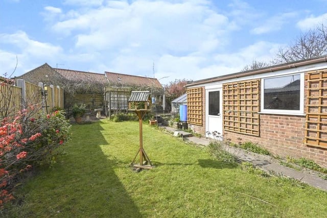 A final look at the £190,000 Sutton bungalow's garden, which also boasts a patio area, greenhouse and outhouse.