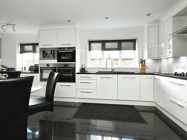 The sleek kitchen is the epitome of contemporary living, thanks to its spacious layout, fitted units and up-to-date appliances. There is an integrated fridge, two ovens, hob, microwave and coffee maker.