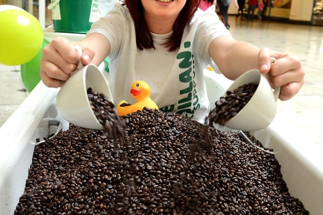 Laura King, aged 20, of Wisewood is pictured sat in a bath of coffee beans in Meadowhall, Sheffield, to raise money for Macmillan Cancer Support in 2012