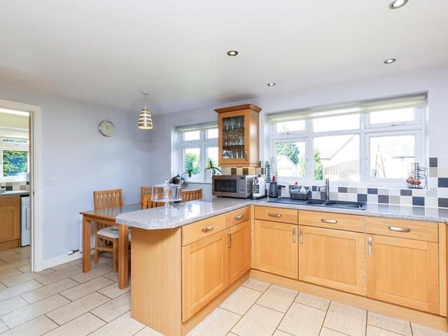 A second glance at the kitchen, where there is space for an American fridge/freezer. As you can see, there is also room for a breakfast table, while to the left is the utility room, which has its own sink and storage units, plus plumbing for a washing machine.,