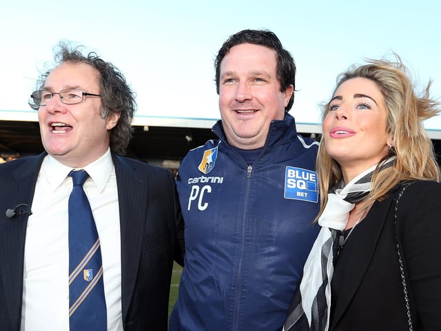 John Radford celebrates with Paul Cox (C) and wife Caroline Radford after Mansfield beat Wrexham to win the Blue Square Bet Premier title and seal the club's return to the Football League.