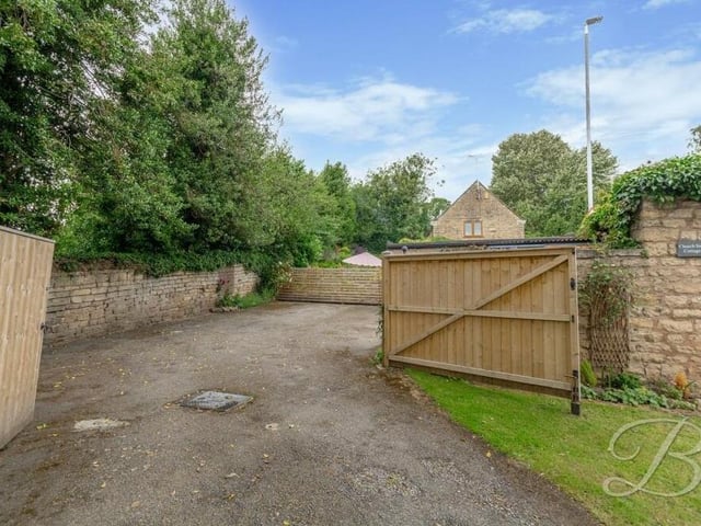 At the front of the property, a spacious driveway provides ample space for off-street parking.