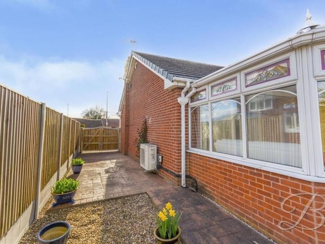 Time to look outside now, and this is the side of the bungalow, having come through the front gates in the distance.