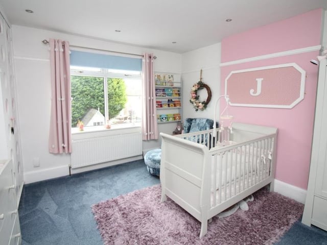Here is another bedroom, currently being used as a child's room. It has a storage cupboard and ceiling spotlights, with a window overlooking the back of the property.