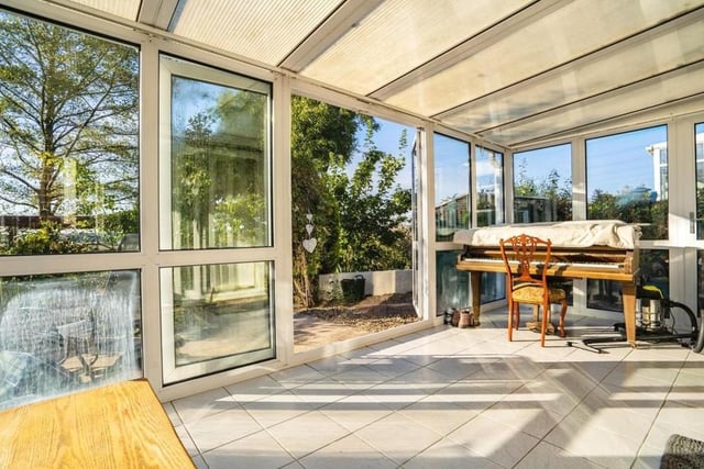 The bright and large conservatory sits at the back of the £575,000 property. It is uPVC-framed with double-glazed windows, tiled flooring and patio doors that lead into the garden.