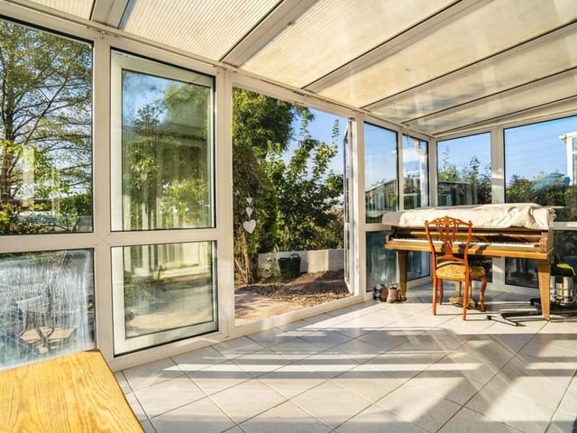 The bright and large conservatory sits at the back of the £575,000 property. It is uPVC-framed with double-glazed windows, tiled flooring and patio doors that lead into the garden.