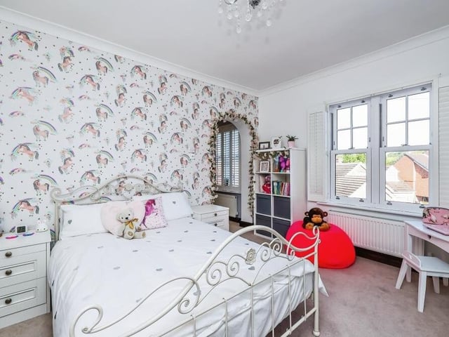 This bedroom has a touch of elegance about it, don't you think? There is space for a dressing table or desk and other furniture.