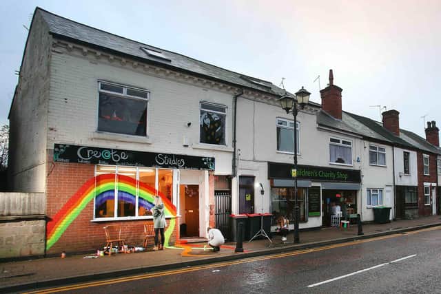 Jayne Woodbridge owner of the Create Studio in Sutton-in-Ashfield, Nottinghamshire, shop front with a giant rainbow as part of Imagine Ashfield, a community project inviting residents to imagine what the area will look like after the pandemic. Picture: Lorne Campbell / Guzelian