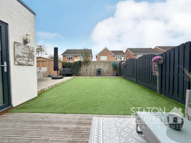 The low-maintenance rear garden features astroturf and two separate seating areas, offering plenty of room for outdoor dining, relaxation and play