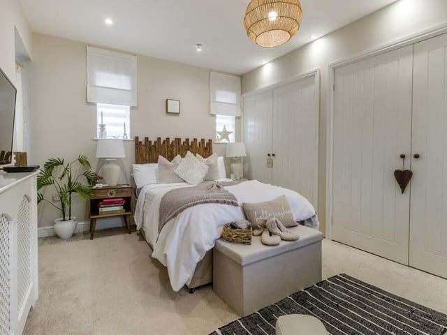 Here is the fourth and final bedroom, which boasts extensive fitted wardrobes, accessed by two sets of double doors. There is lots of space for bedroom furniture too.