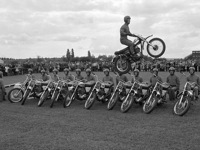 Thrilled crowds watch this motorbike stunt in 1973.