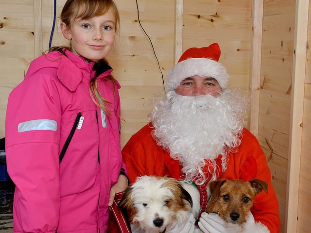 Santa Paws Dog Grotto at Mansfield Market in aid of Guide Dogs for the Blind Association, pictured is Daisy, 10 with Fudge and Toffee meeting Santa.