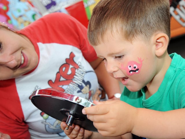 Archie Ansty, 2, checks out his face paint design.