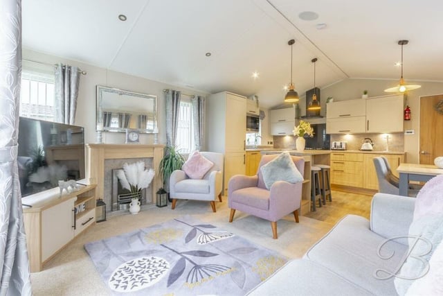 Next to the kitchen/dining room is this living room, which is described by estate agents BuckleyBrown as "simply stunning".