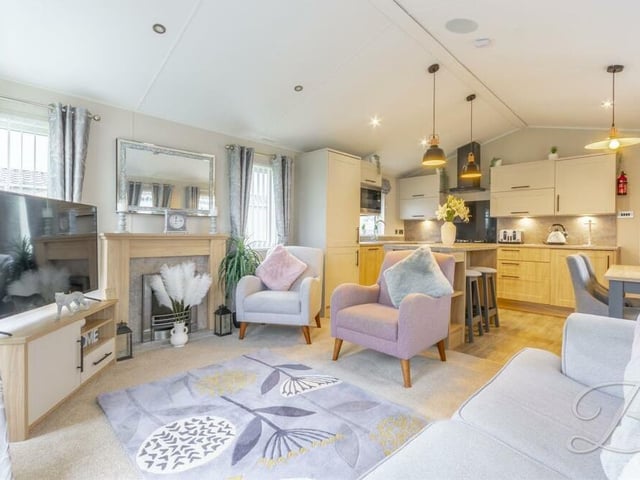 Next to the kitchen/dining room is this living room, which is described by estate agents BuckleyBrown as "simply stunning".