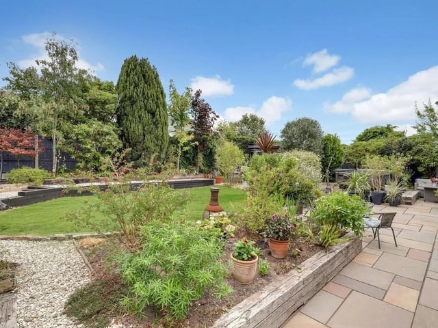 To the rear of the property is a spacious and well-established enclosed garden, featuring a generous patio area providing an ideal space for outdoor dining and entertaining.