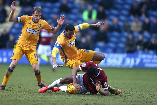 Ivan Toney of Northampton Town attempts to control the ball under pressure from Vadaine Oliver of Mansfield in 2015.