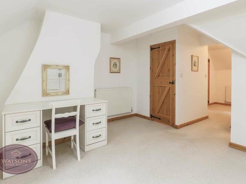 The main bedroom is so large that it includes a dressing room, with dressing table, plus access to an en suite shower room..