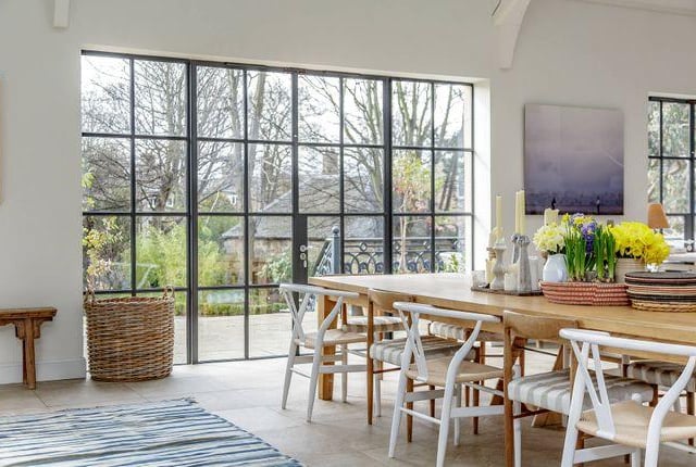 Built for entertaining, this dining room has large windows overlooking the garden.