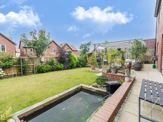 Another highlight of the garden at the £490,000-plus Mansfield property is this decorative pond, which sits alongside a well-maintained lawn and various plants and shrubs.