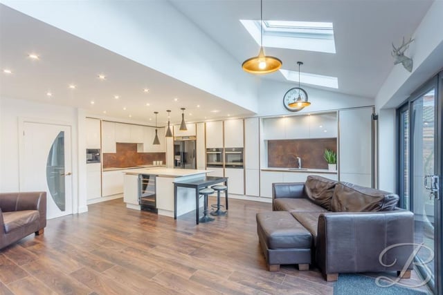 A chance to stand back and admire the kitchen, which also has a living area, with space for sofas, while bi-folding doors give access to the garden.