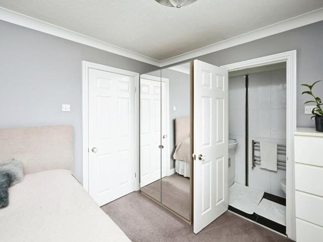 This bedroom at the back of the house boasts not only wardrobe space but also access to an en suite room.