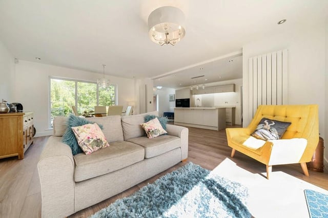 This is the living room or lounge section of the ground-floor open-plan area. It is a bright and comfortable space, with bi-folding doors leading to the back garden.
