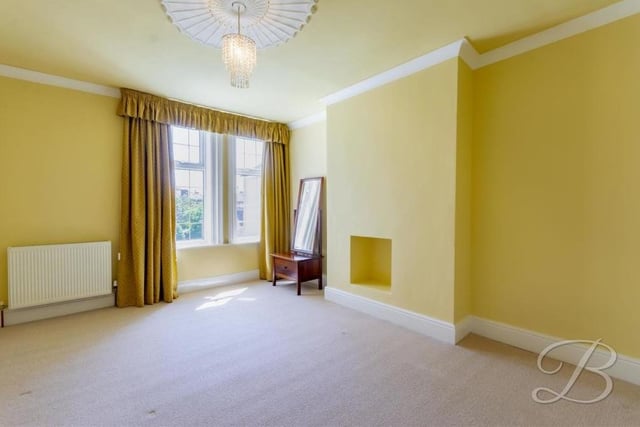 A feature of the second bedroom is that there is a space built into the wall for a fireplace, if required. It is a lovely room, with a carpeted floor and a bright and breezy decor.