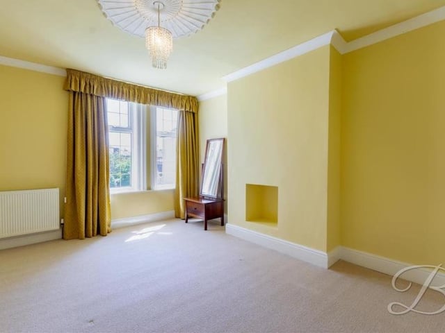 A feature of the second bedroom is that there is a space built into the wall for a fireplace, if required. It is a lovely room, with a carpeted floor and a bright and breezy decor.