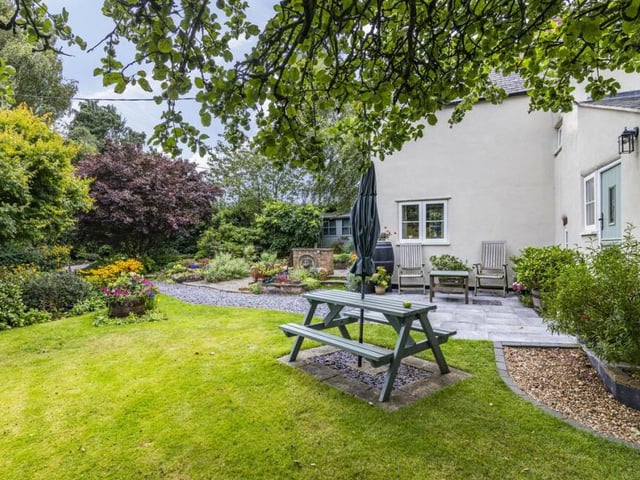 Lush lawns and overhanging trees paint the picture of a peaceful escape.