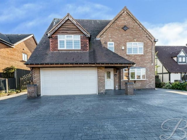 Returning to the front of the property, where a block-paved driveway offers off-street parking space and leads to a substantial garage.