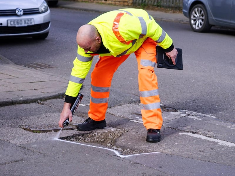 Poyhole repairs. Gary Wright senior highways inspector at the site of a pothole reported by the public in Ashfield.