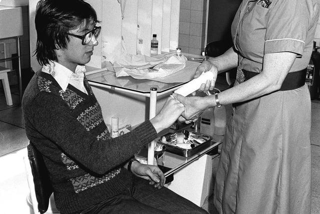 September 1980 - Sister Marion Foster dresses an injury at Thoresby Colliery.