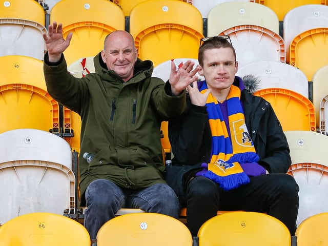 Mansfield Town fans watch the match against Northampton Town.