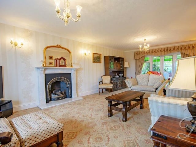 The first room on our tour of the house is this lovely lounge or living room, which has been beautifully decorated in a neutral colour palette. A feature fireplace makes a great statement.