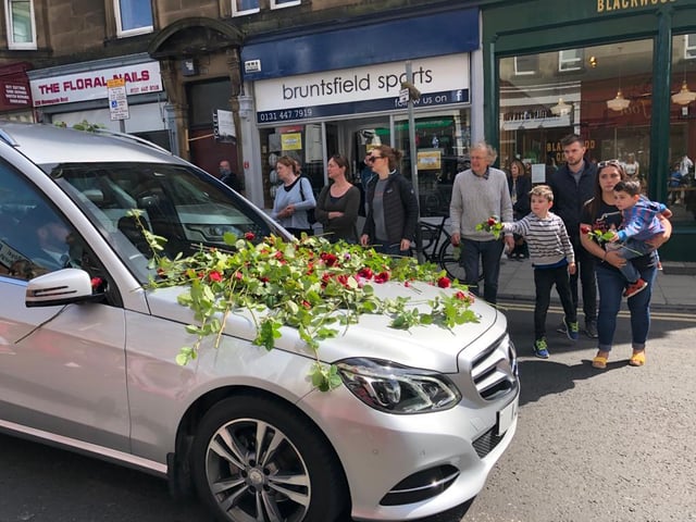 Xander passed through Morningside at around 11:10am and those waiting laid the roses on the bonnet of the car