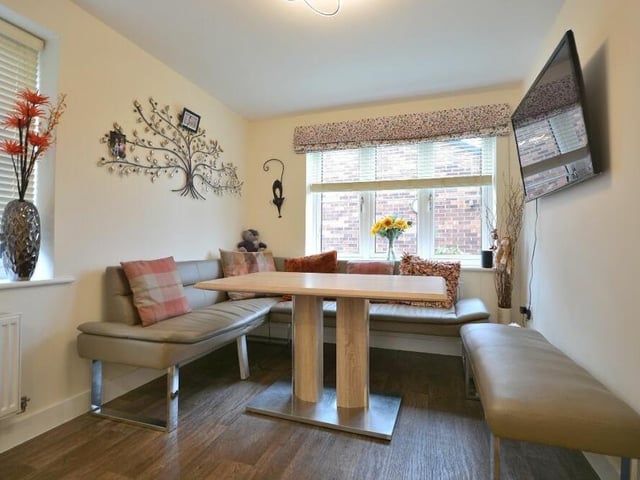 This is a close-up of the smart dining area at one end of the open-plan kitchen. It is a bright and pleasant space, ideal for family meals.