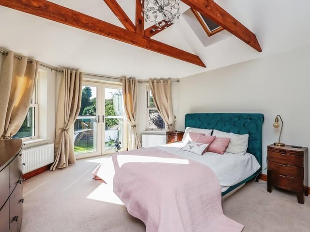 Time to go upstairs now to check out the four bedrooms, starting with the master. Its prize assets are the beamed ceiling and the doors opening out on to a Juliet balcony, which offers breathtaking views of the back garden and the countryside beyond.