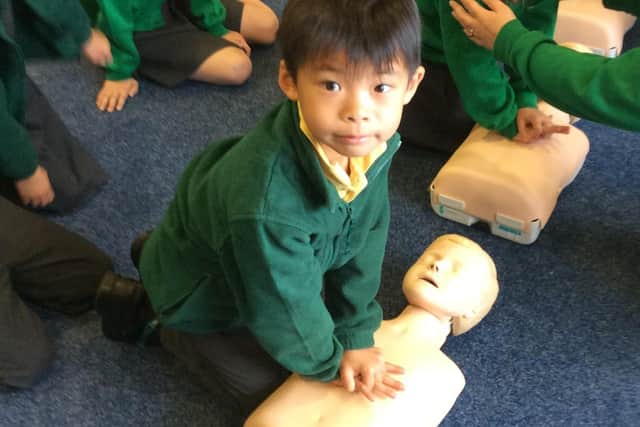 A Gilthill Primary School pupil practicing CPR on a dummy.
